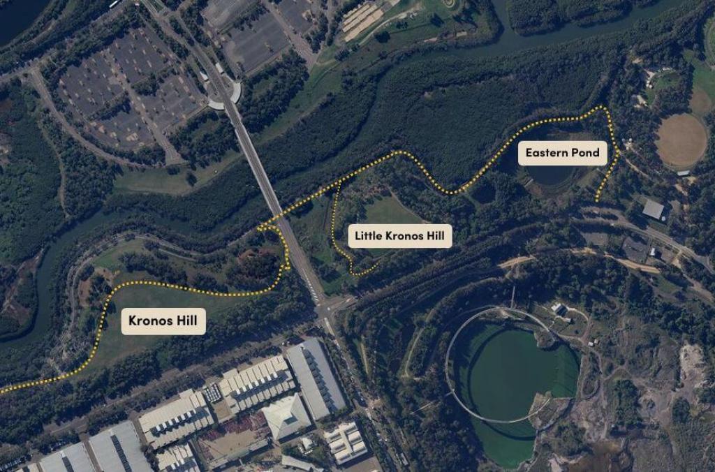 Overhead satellite map over Sydney Olympic Park, centred on Haslams Creek. Four landmarks are joined by a drawing of a path, and are labelled from right to left: Eastern Pond, Little Kronos Hill, Kronos Hill, Northern Water Feature.